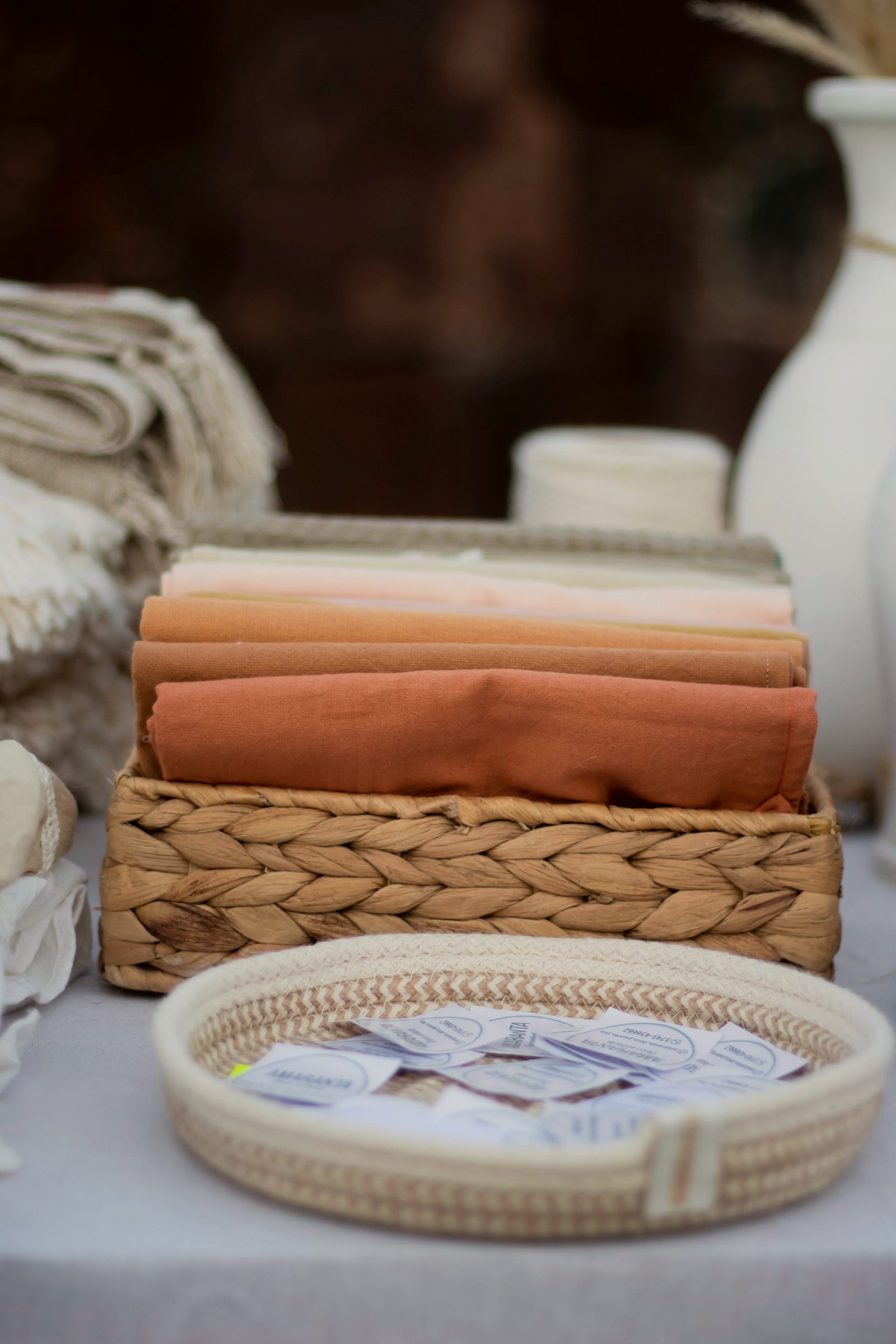 Folded textiles arranged in a woven basket